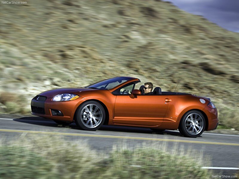 orange convertible driving on road