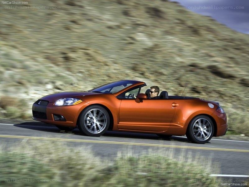 orange convertible driving on road