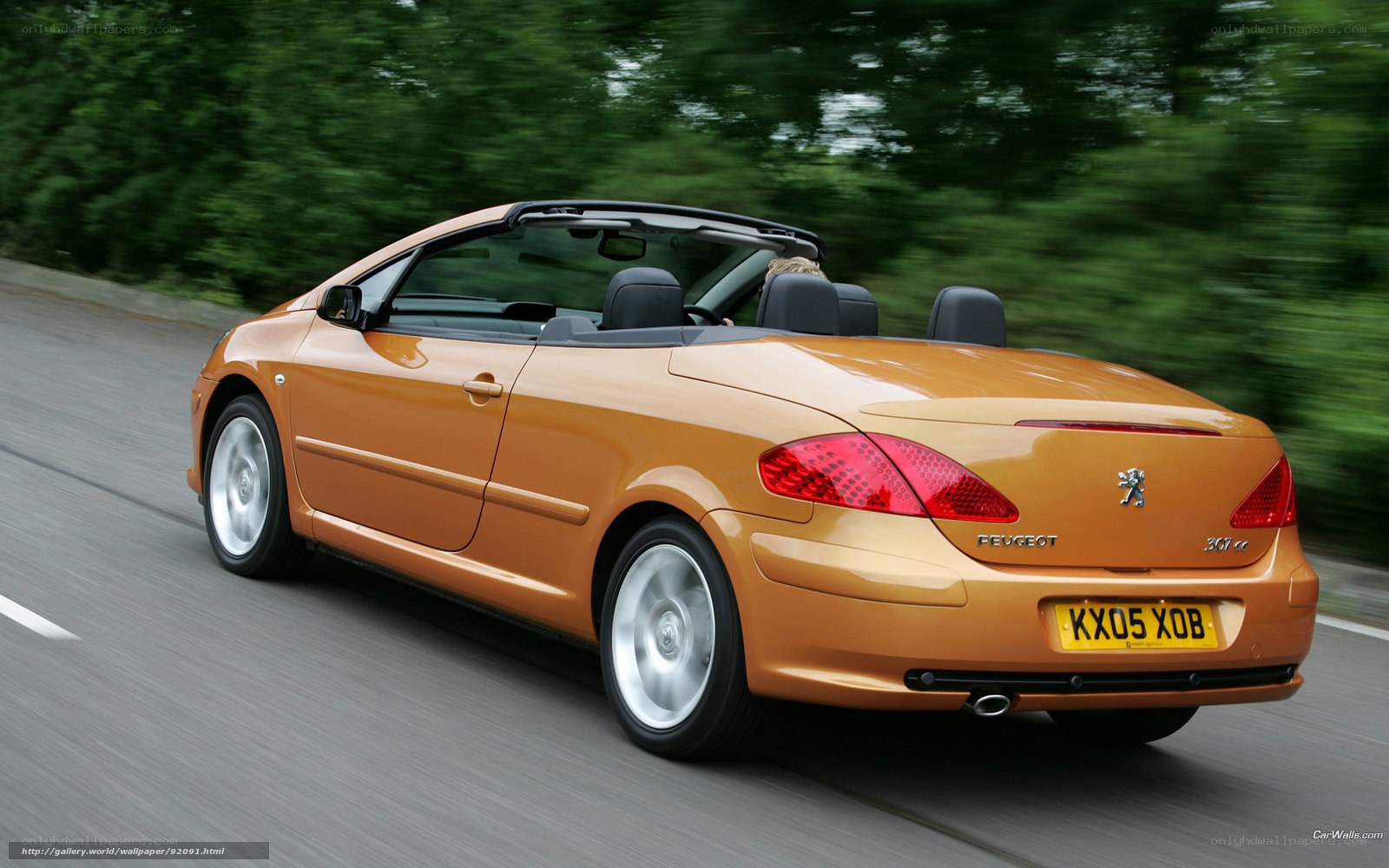 orange convertible driving on road