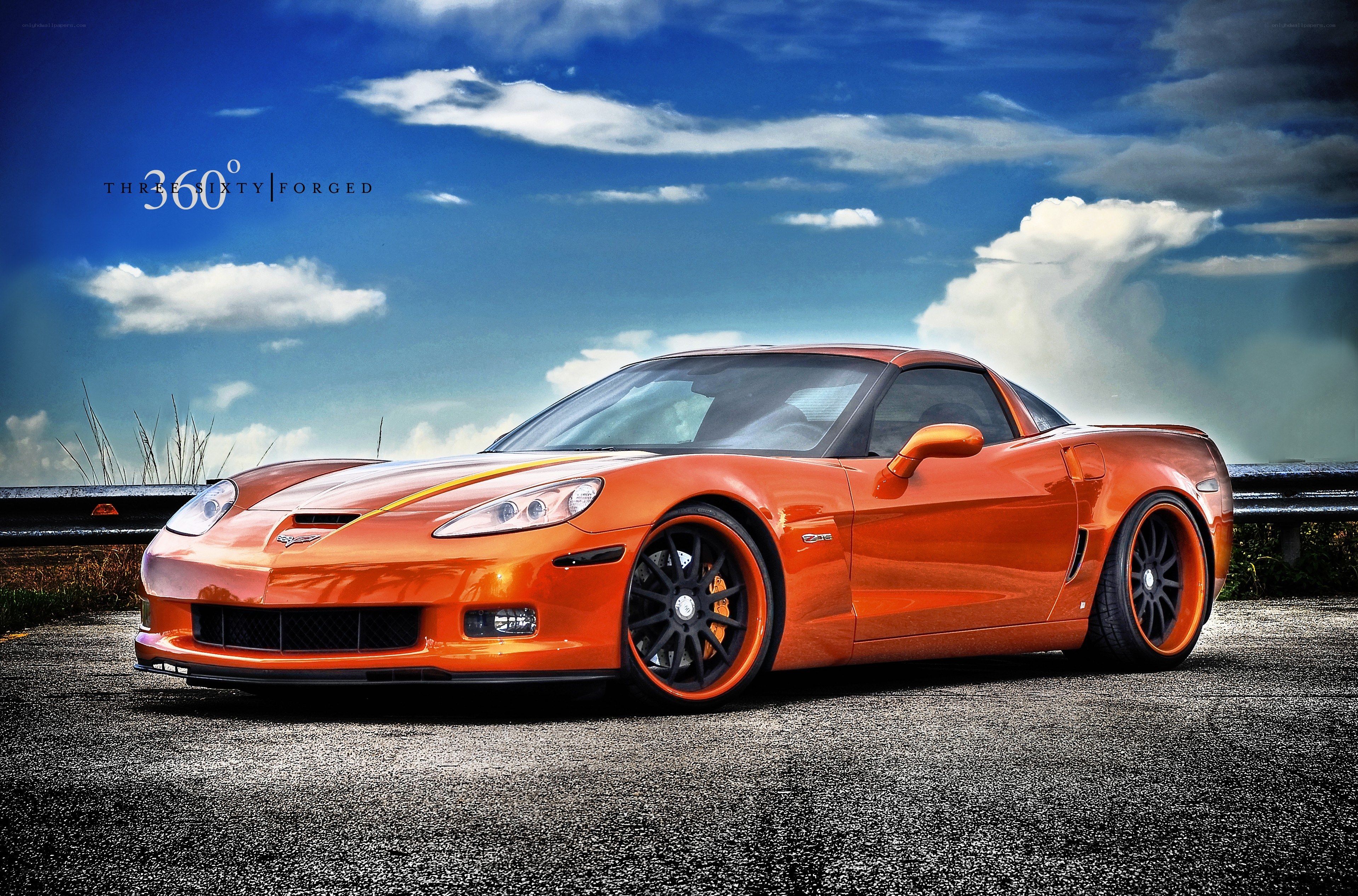 Orange Corvette on a scenic road