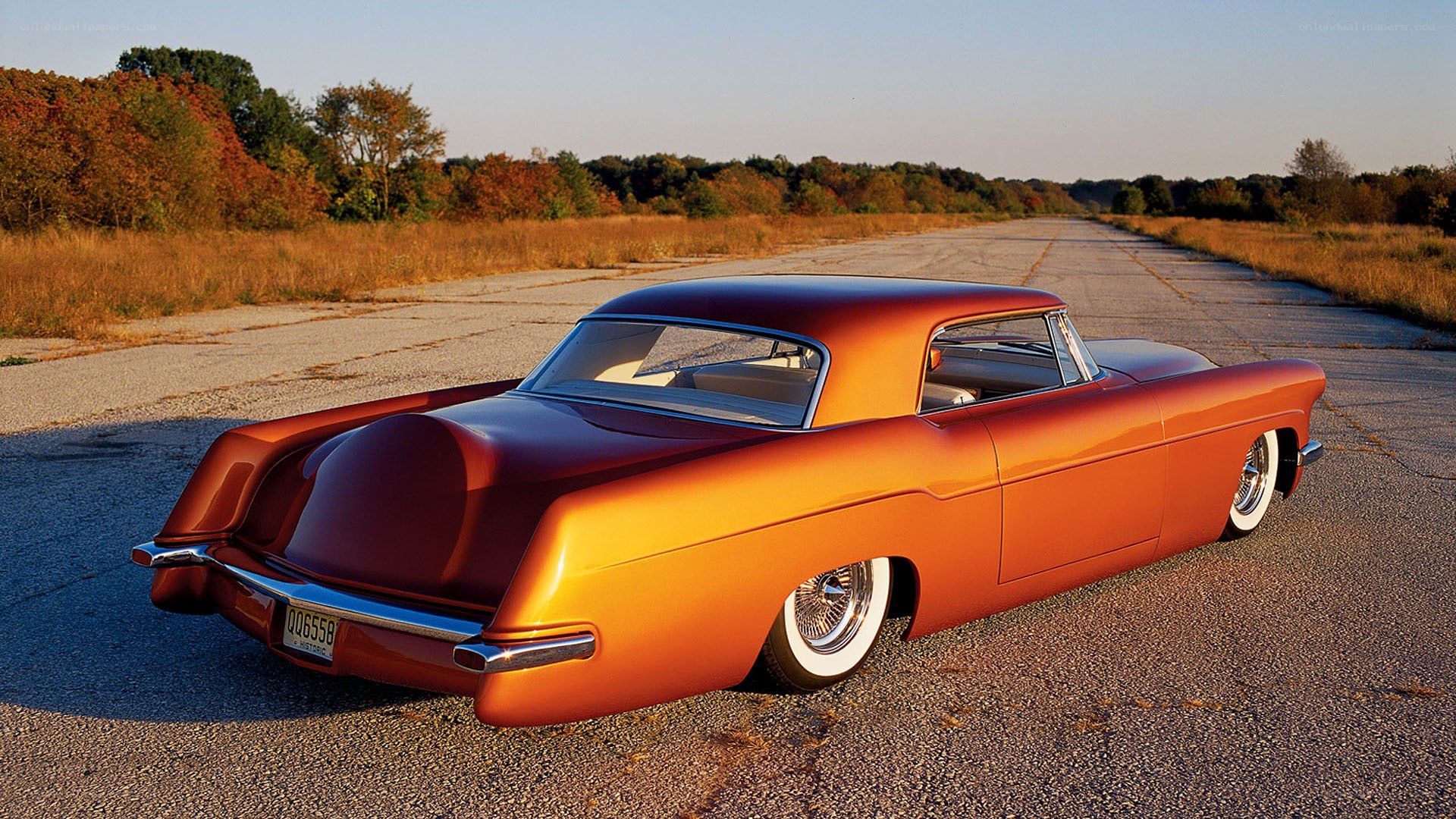 orange custom car on road