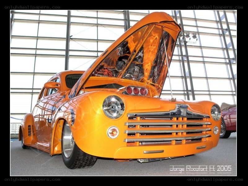 orange custom car with open hood