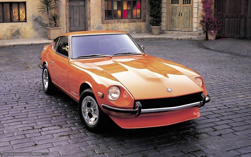 Orange Datsun 240Z on cobblestones