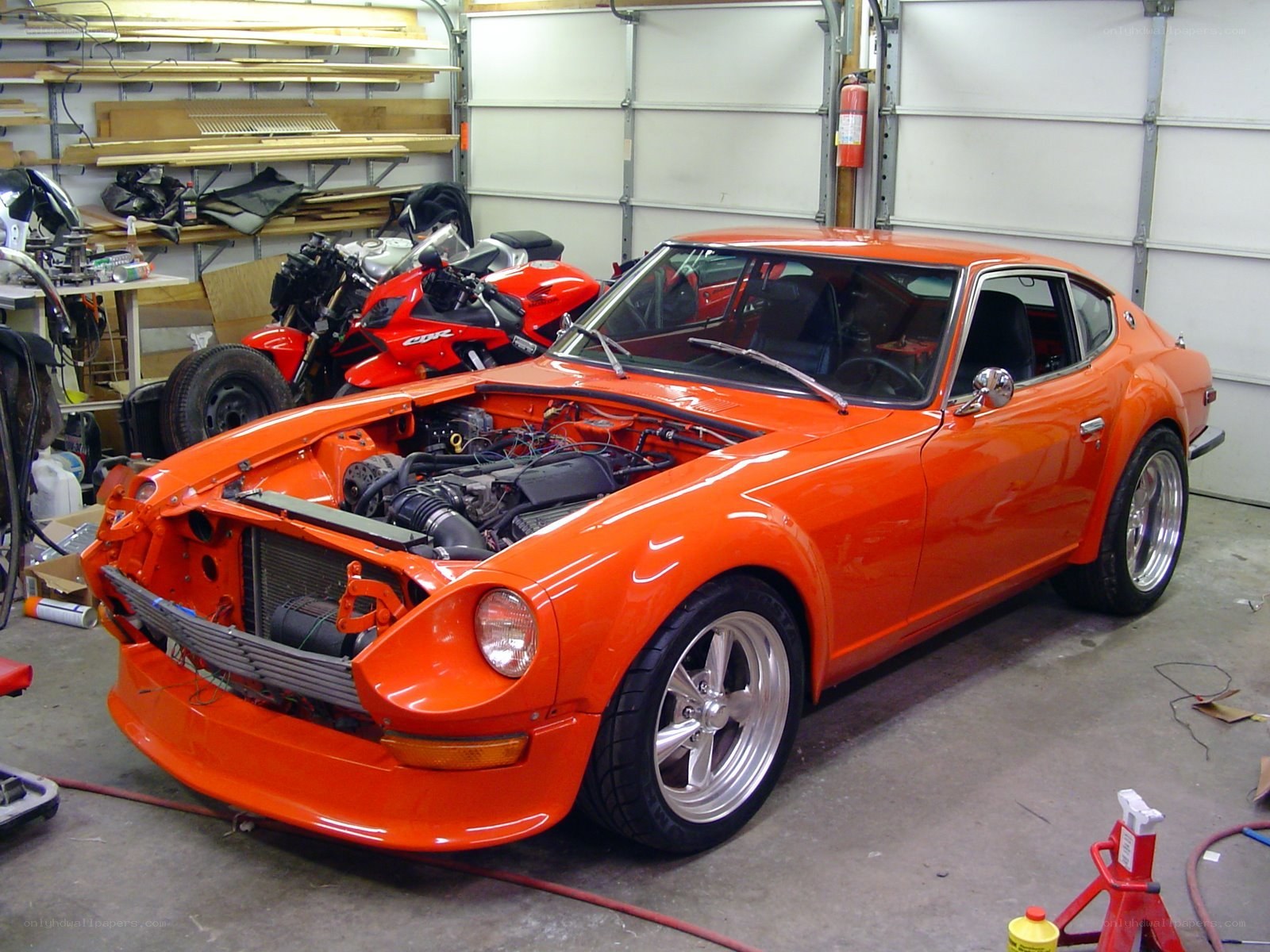 Orange Datsun in a garage