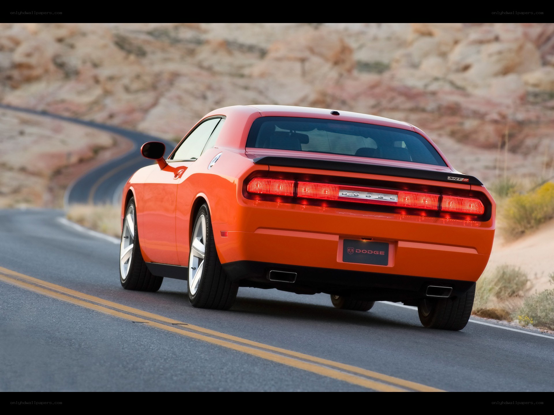 Orange Dodge Challenger on a desert road