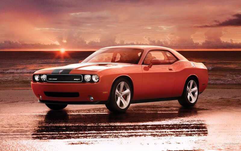 Orange Dodge Challenger on beach