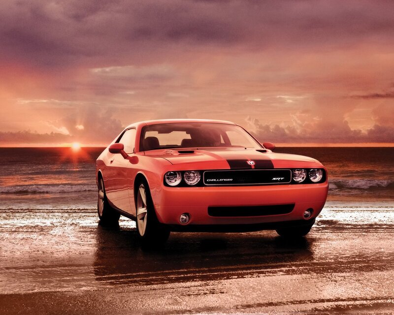 Orange Dodge Challenger on beach