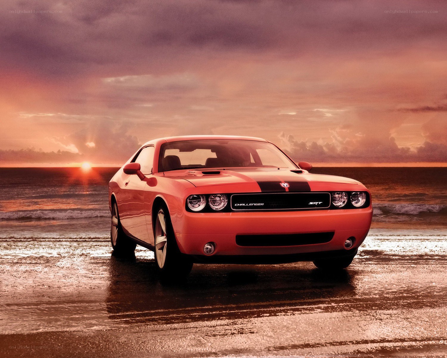 Orange Dodge Challenger on beach