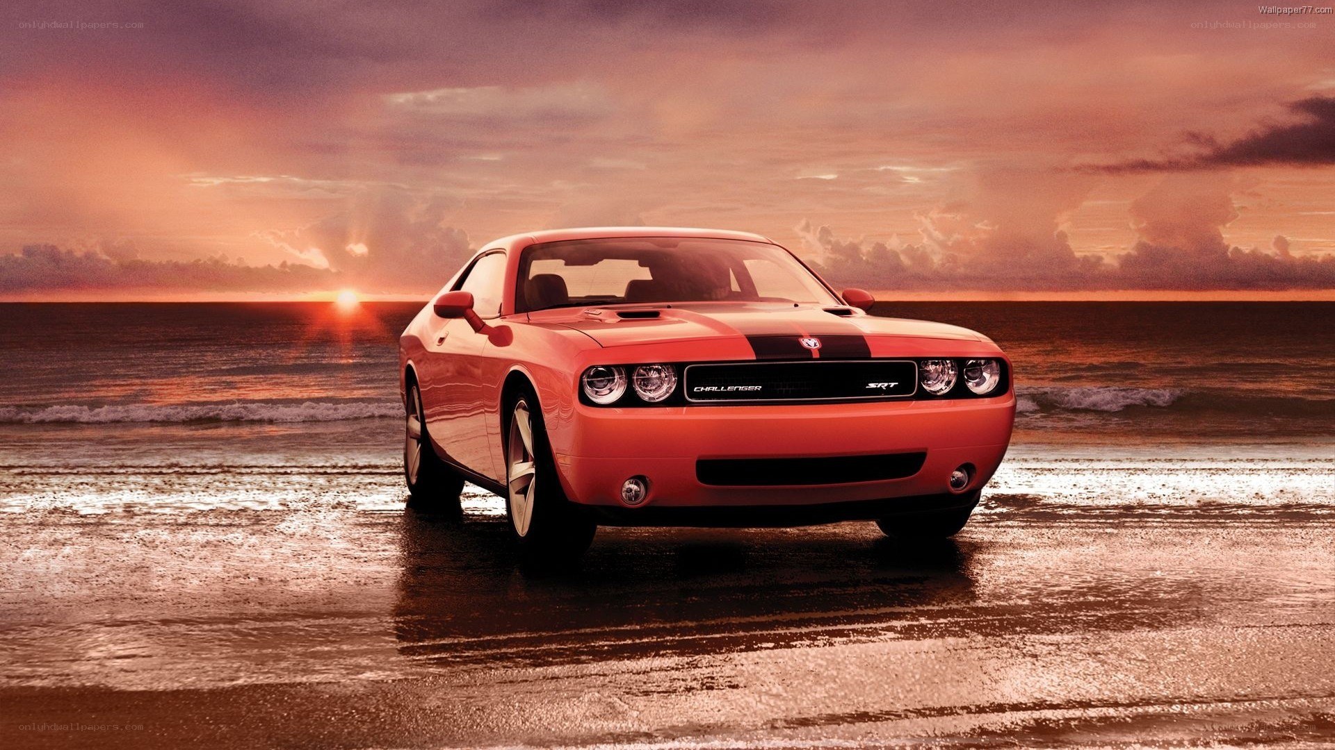 Orange Dodge Challenger on beach