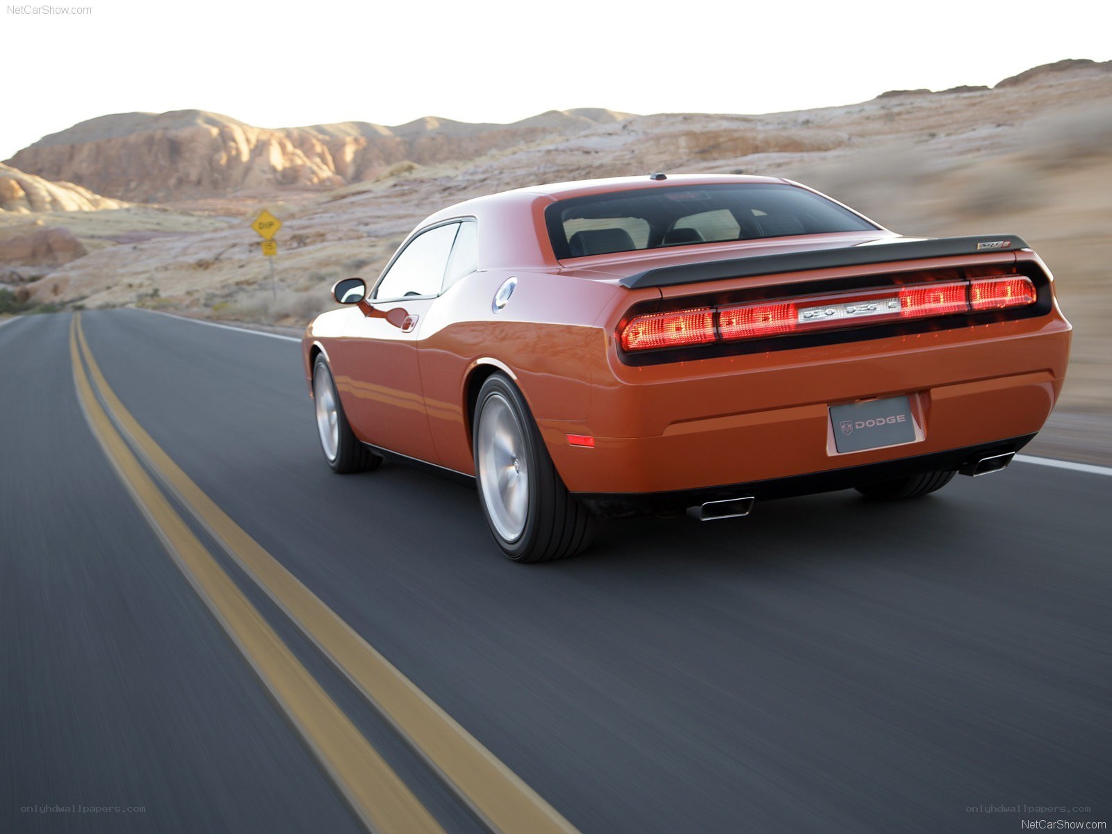 Orange Dodge Challenger on desert road