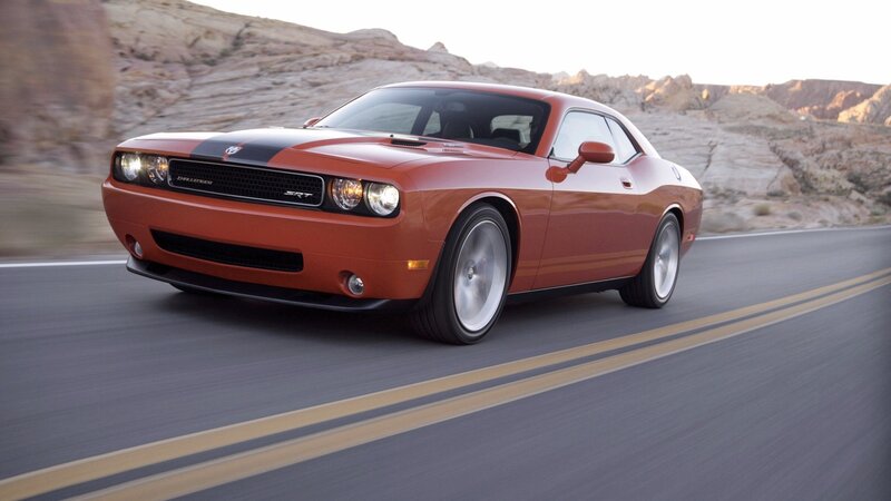 Orange Dodge Challenger on desert road