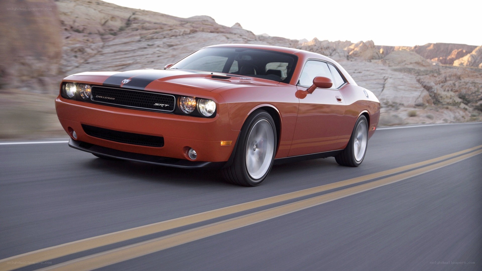 Orange Dodge Challenger on desert road