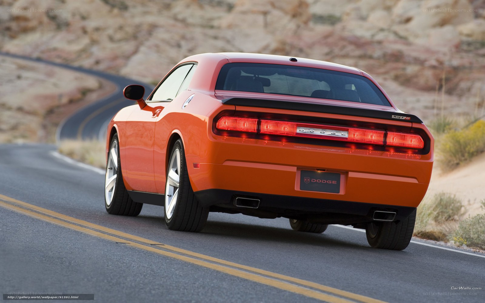 Orange Dodge Challenger on desert road