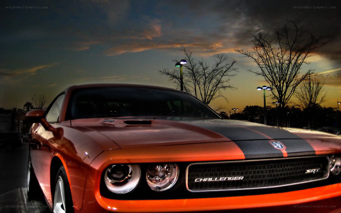 Orange Dodge Challenger SRT at dusk