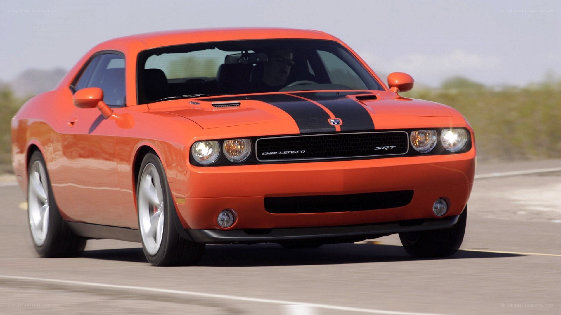 Orange Dodge Challenger SRT in motion