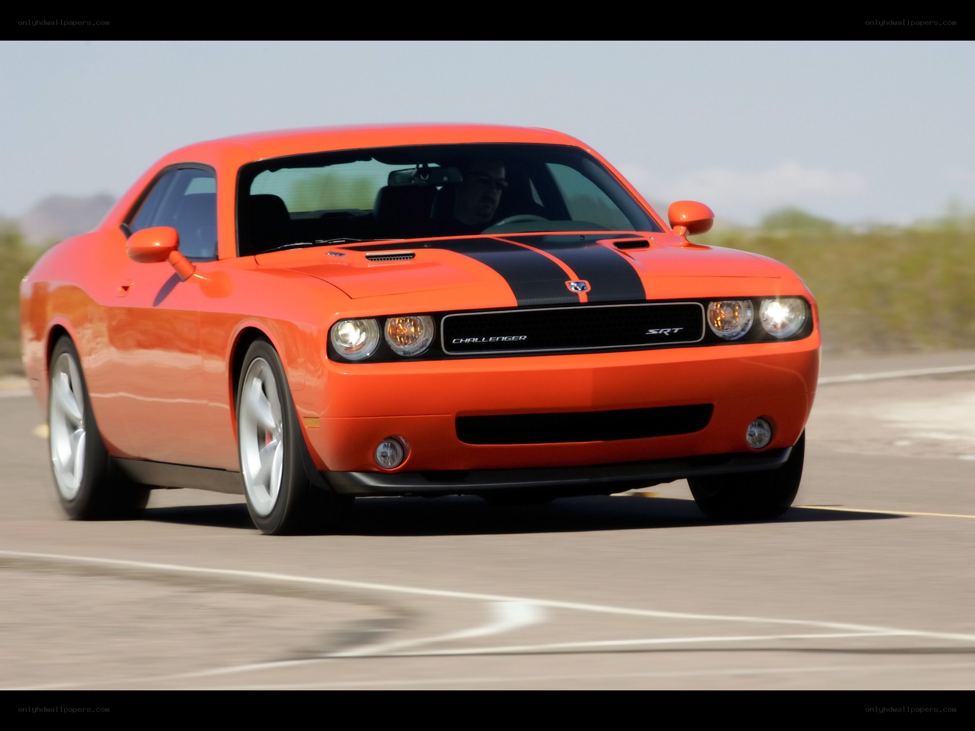 Orange Dodge Challenger SRT in motion
