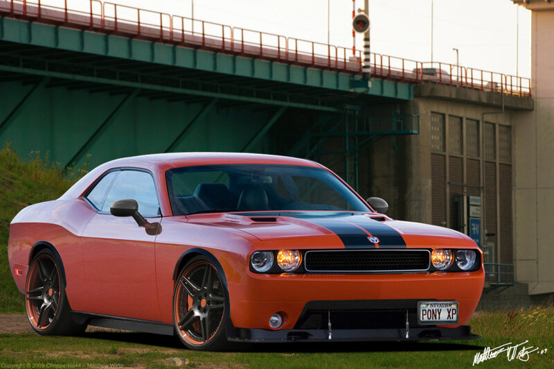 Orange Dodge Challenger under bridge