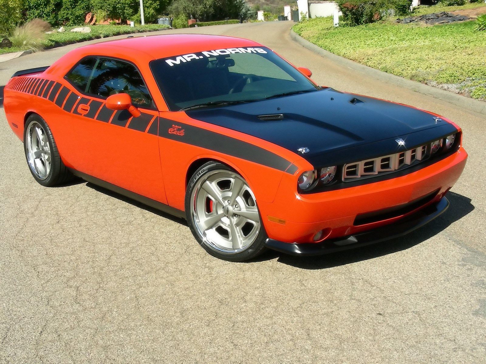 Orange Dodge Challenger with black hood