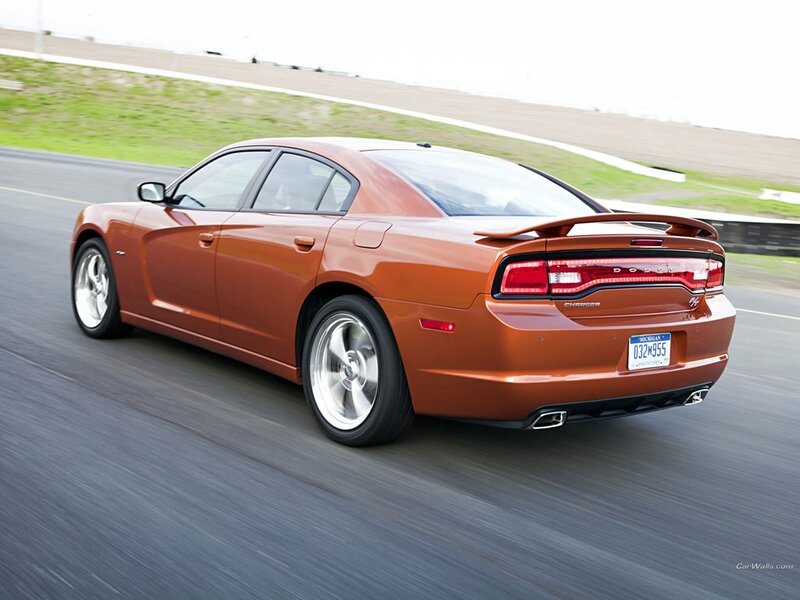 orange dodge charger in motion