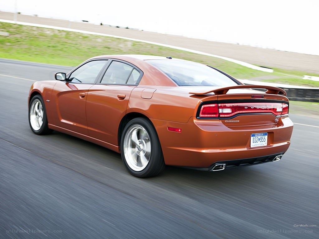 orange dodge charger in motion