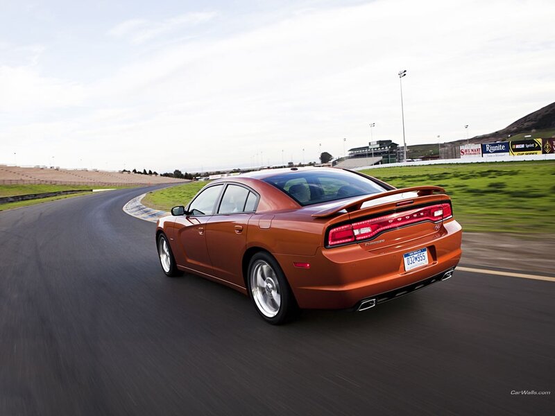 orange dodge charger on racetrack