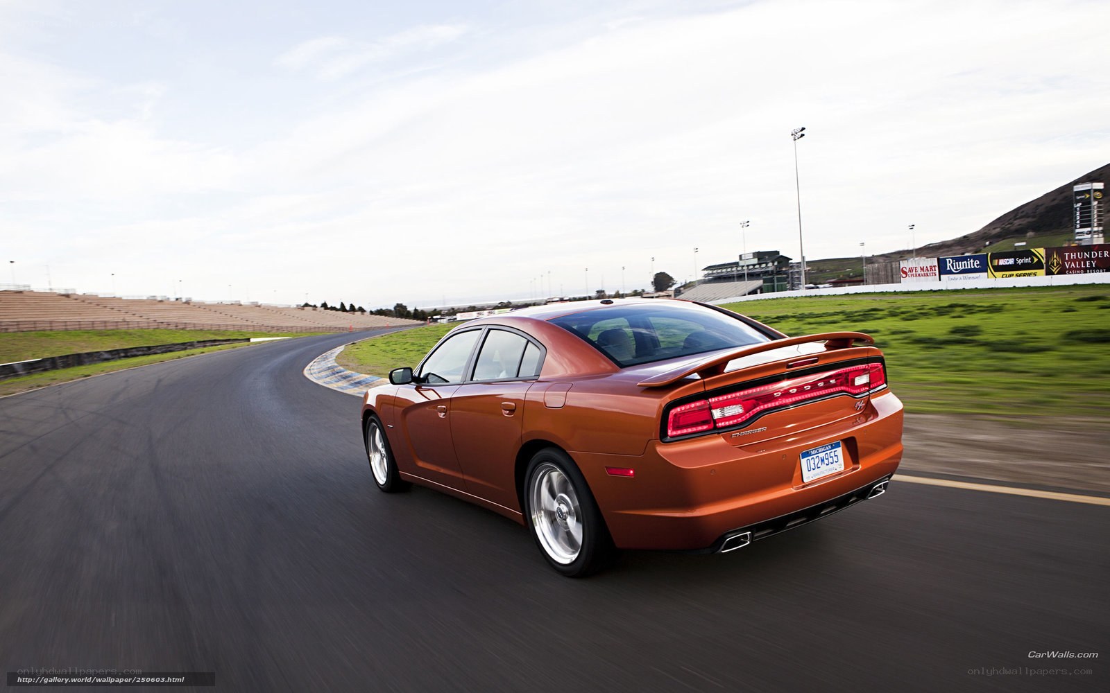 orange dodge charger on racetrack