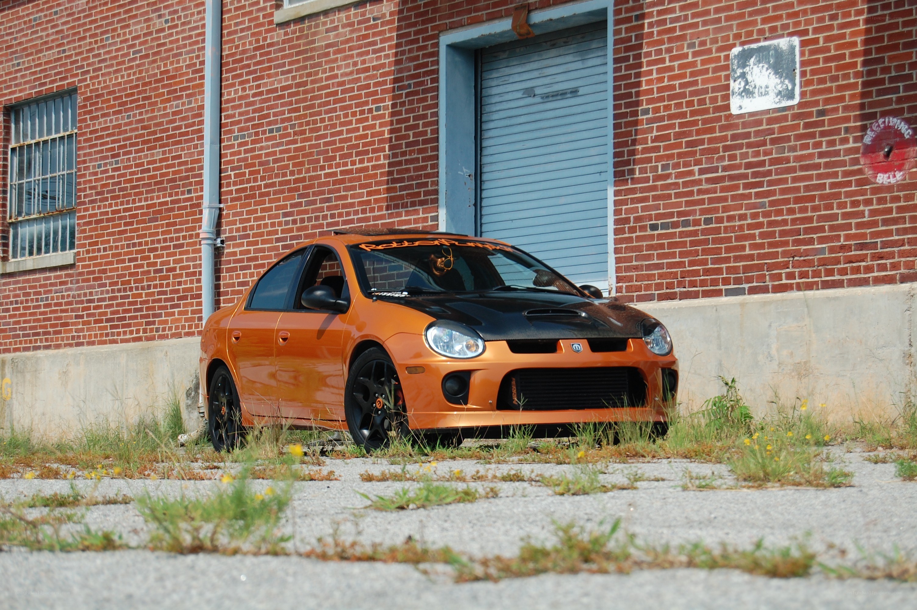 orange dodge neon parked outside