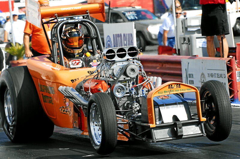 Orange drag racing car at track