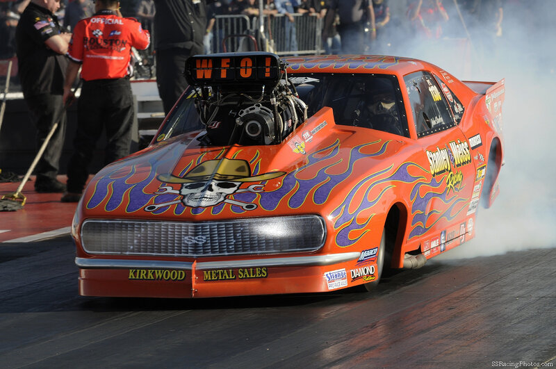 Orange drag racing car on track