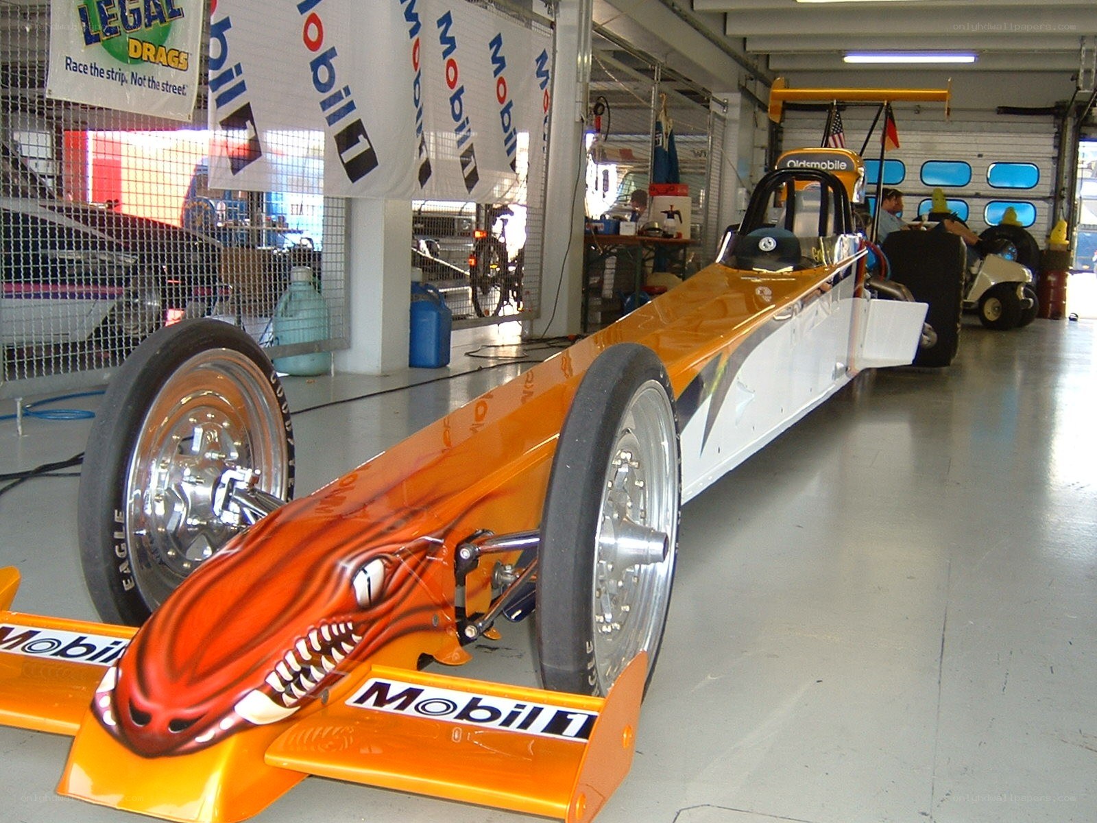 Orange dragster in garage