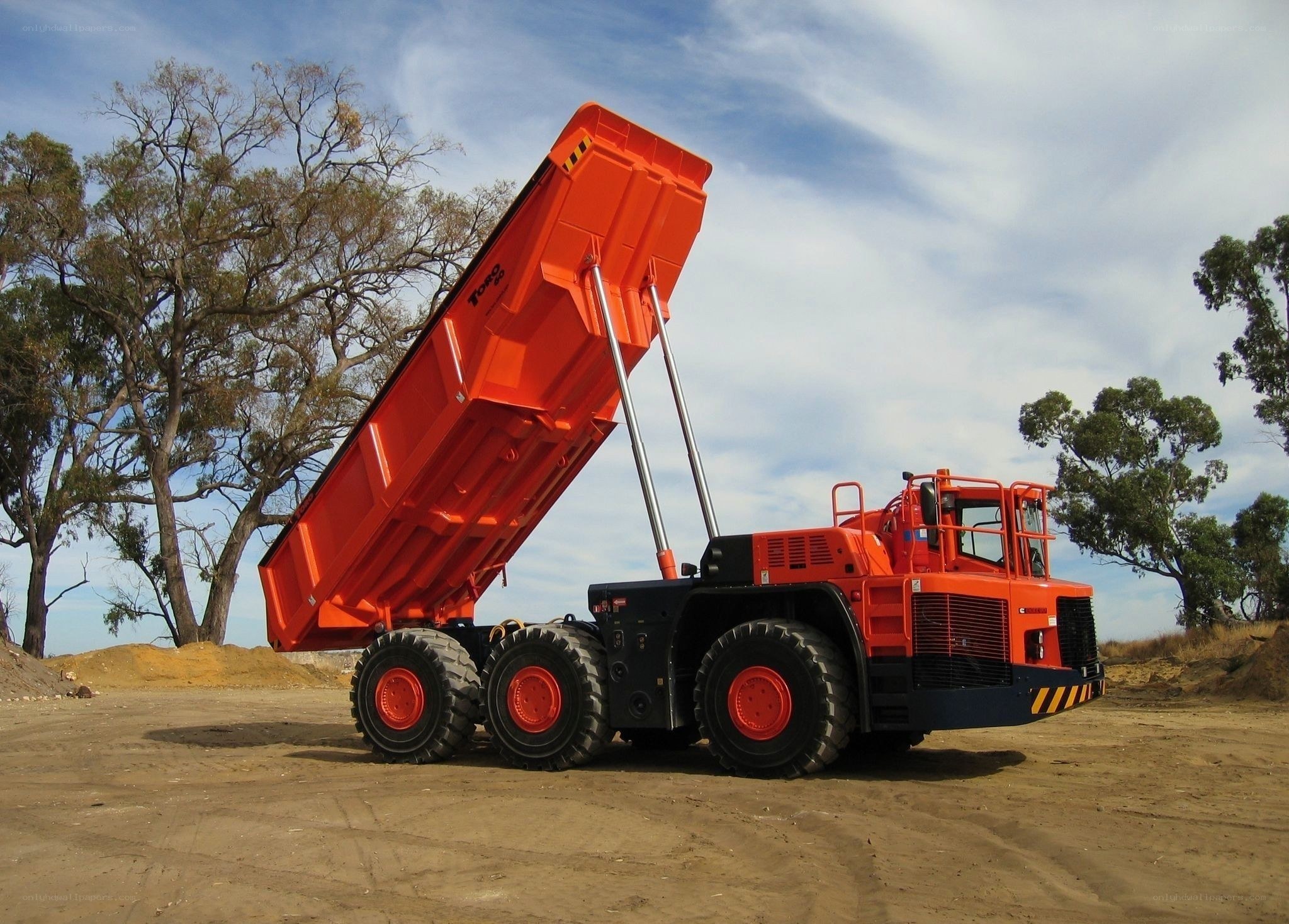 Orange dump truck at construction site