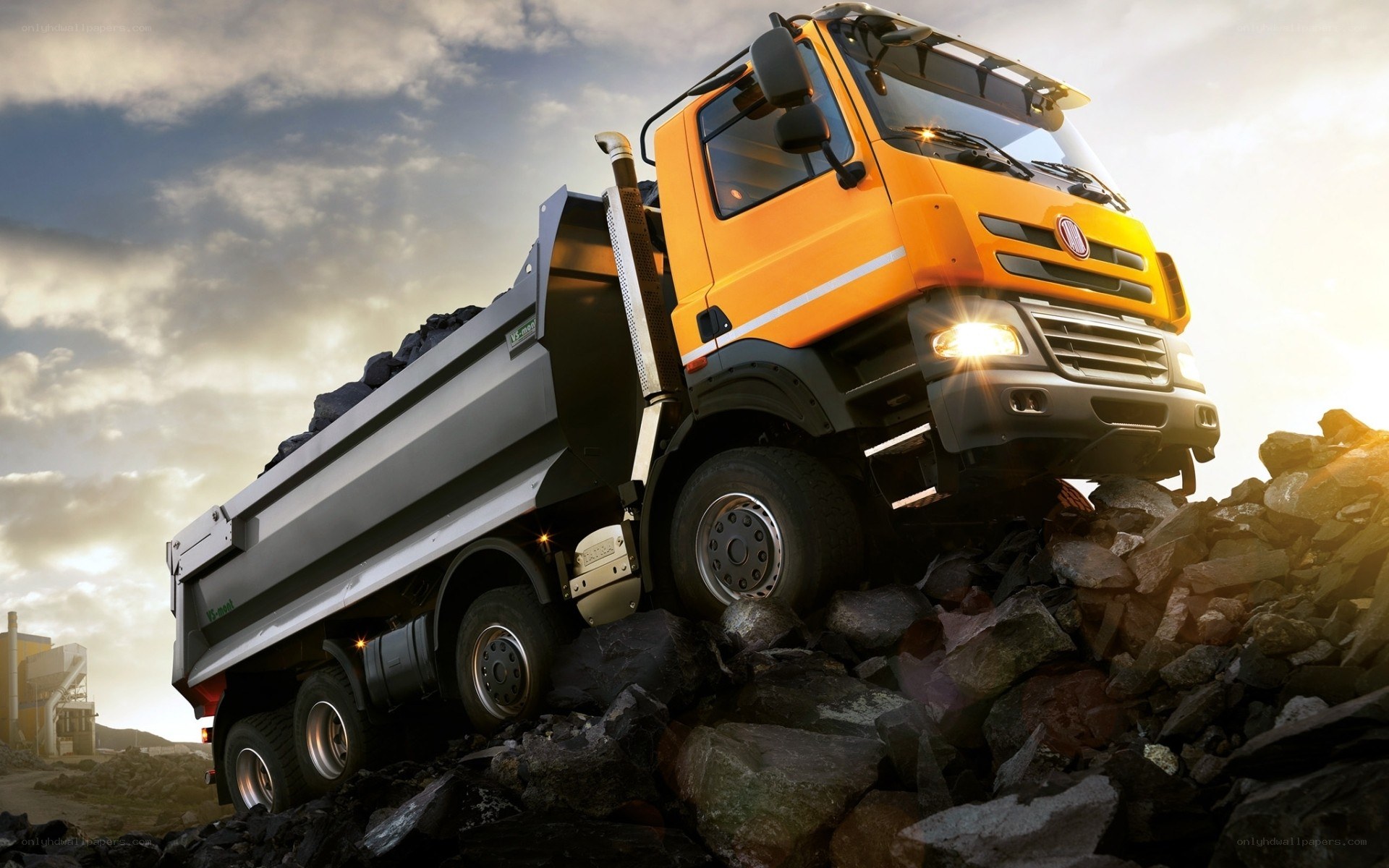 orange dump truck on rocks