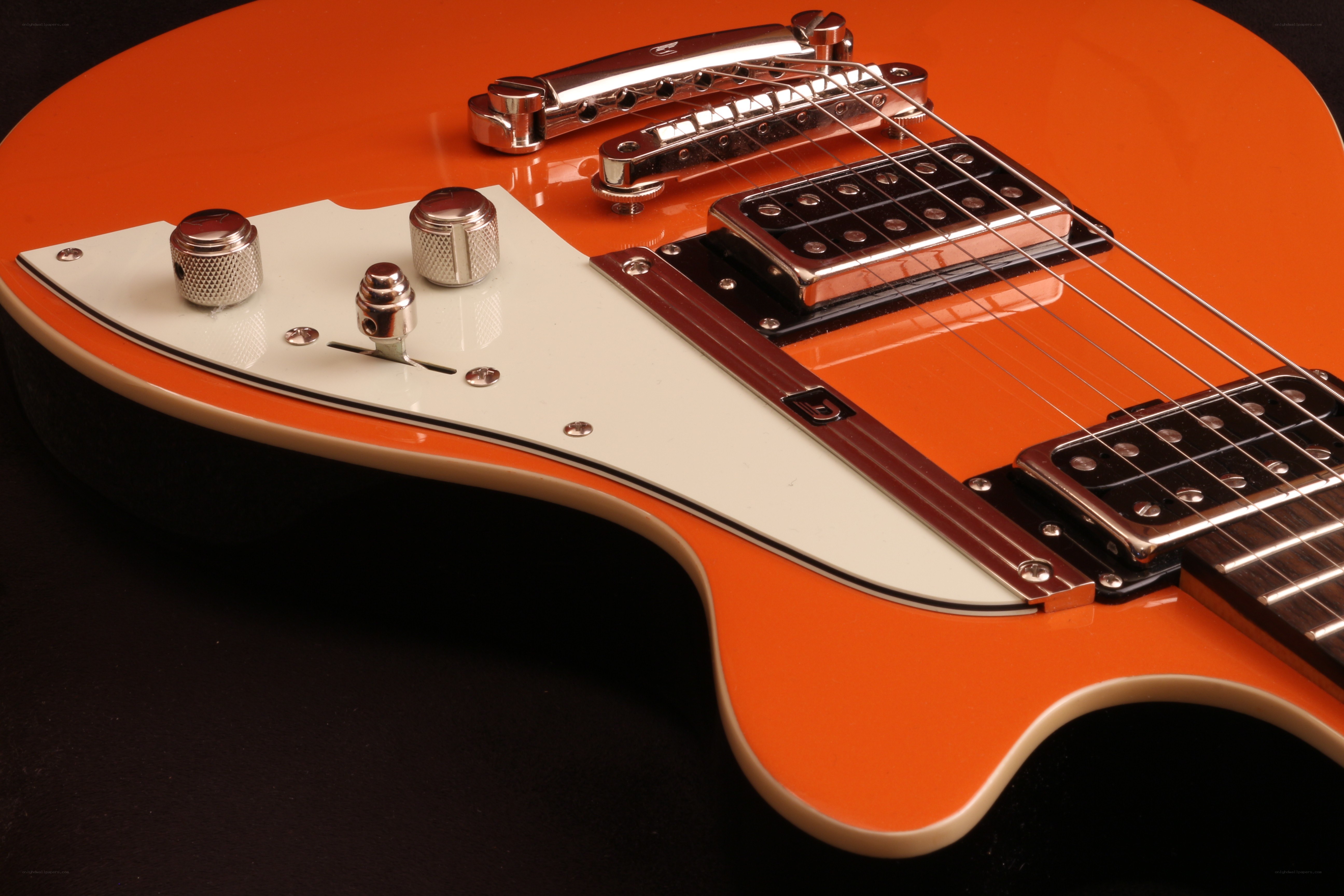 orange electric guitar close-up