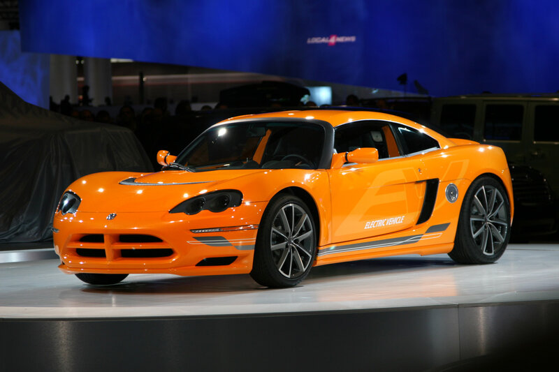 Orange electric sports car on display