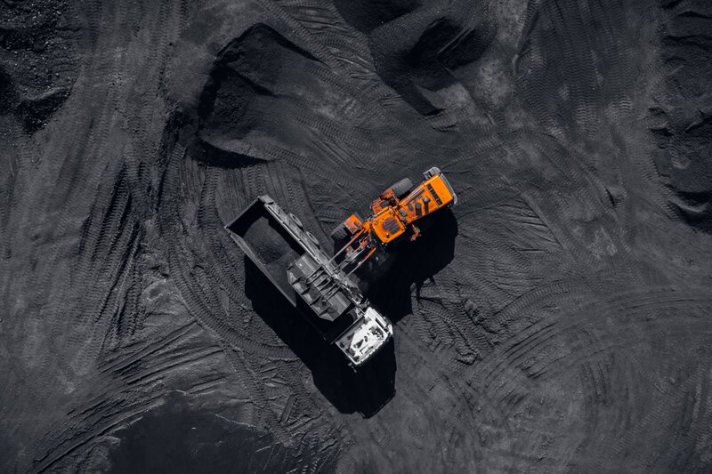 Orange Excavator Loading Truck