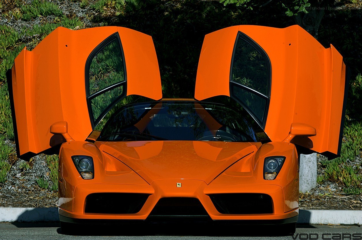orange ferrari enzo with doors open