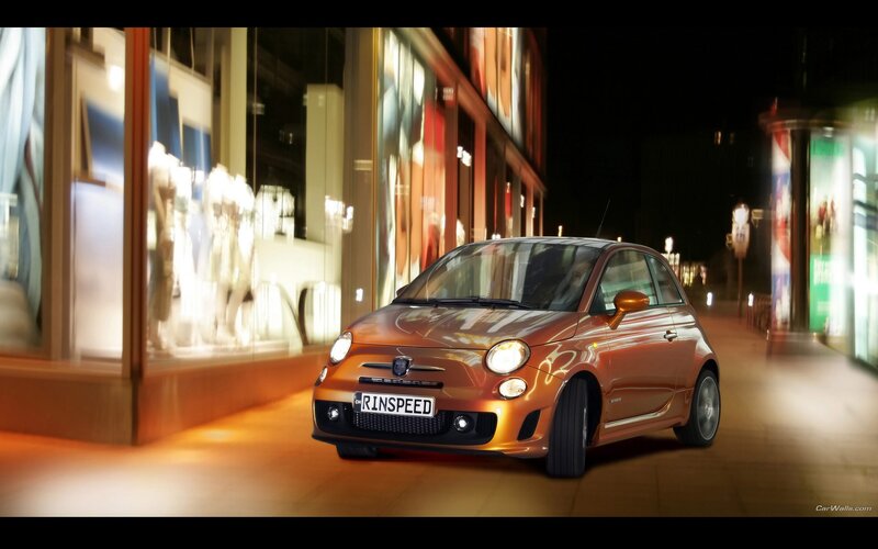 Orange Fiat in city at night