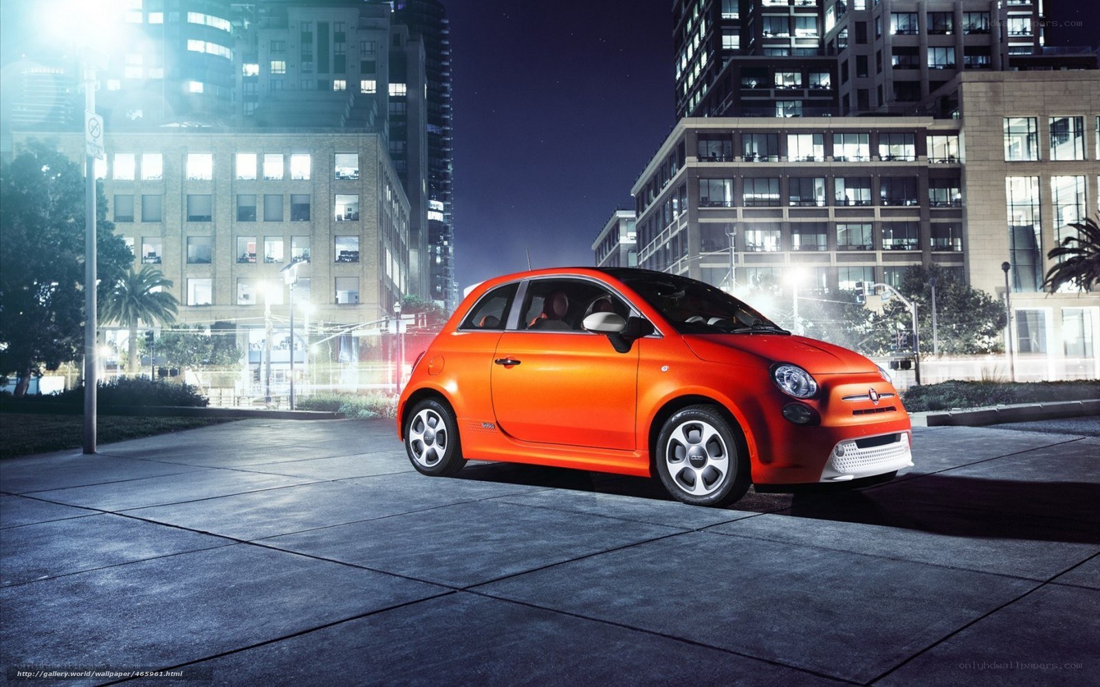 Orange Fiat in city at night