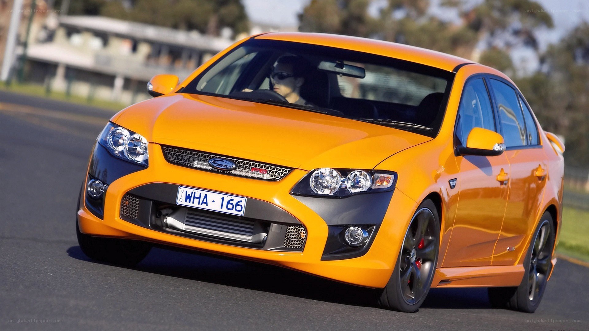orange ford falcon in motion