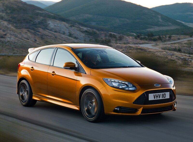 Orange Ford Focus driving on mountain road