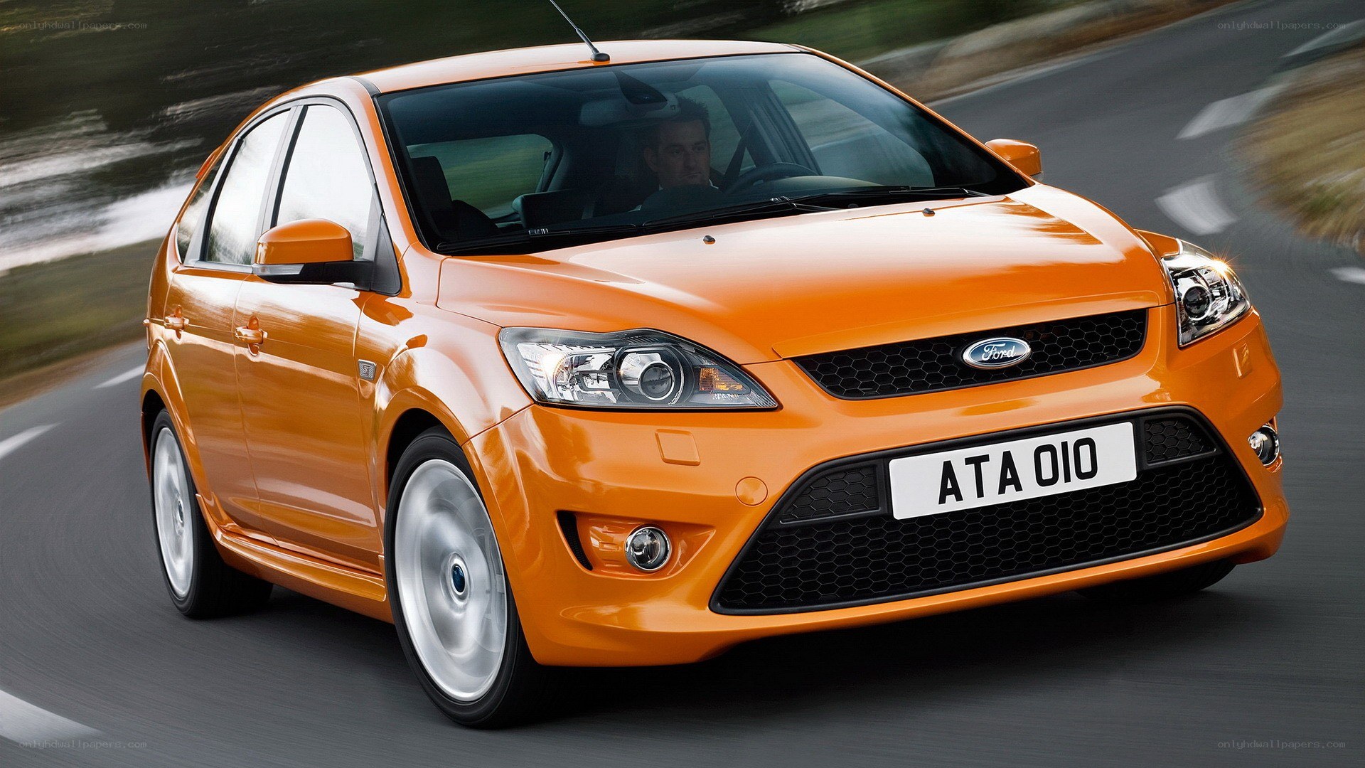 orange ford focus in motion