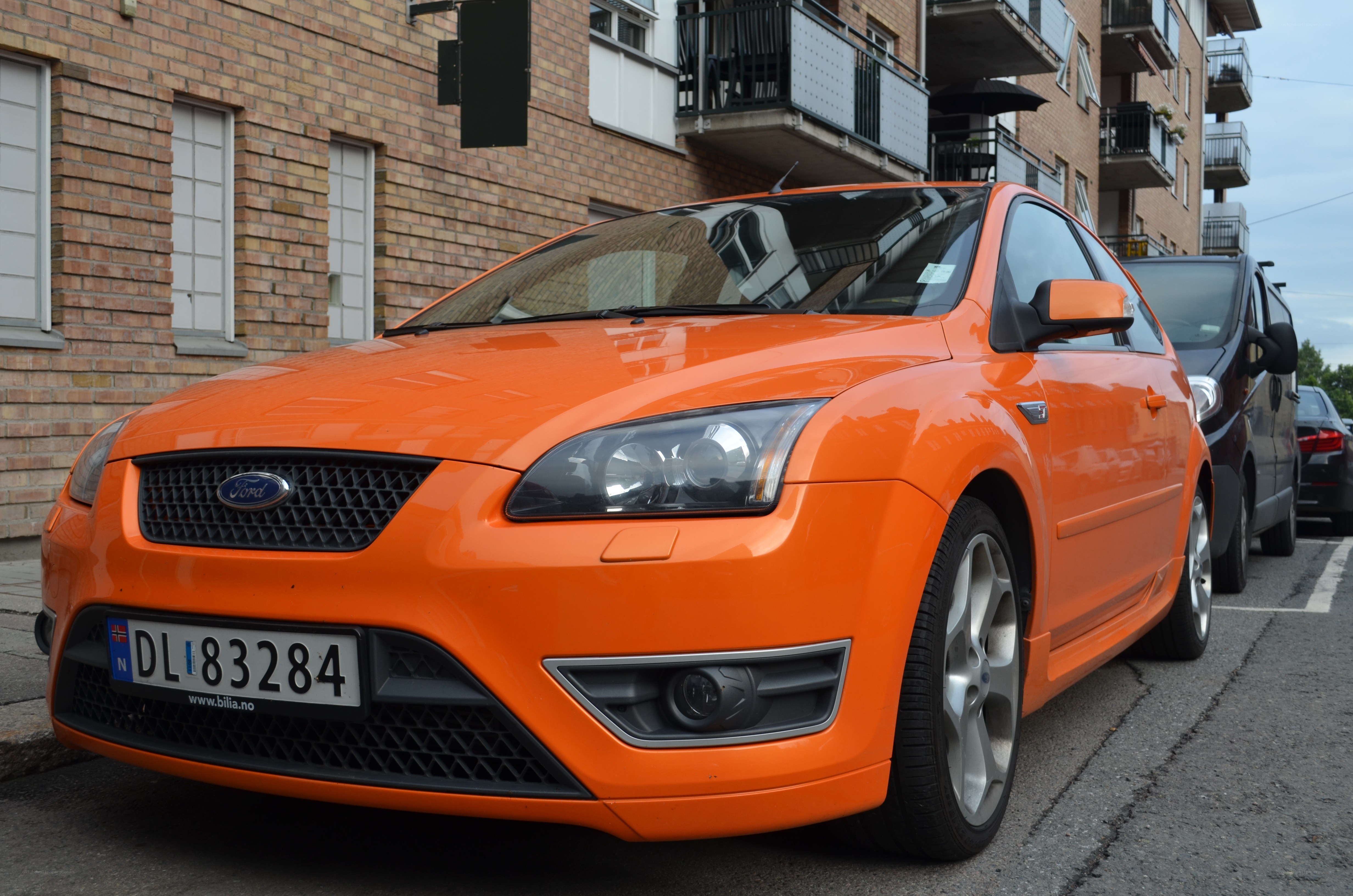 orange ford focus parked on street