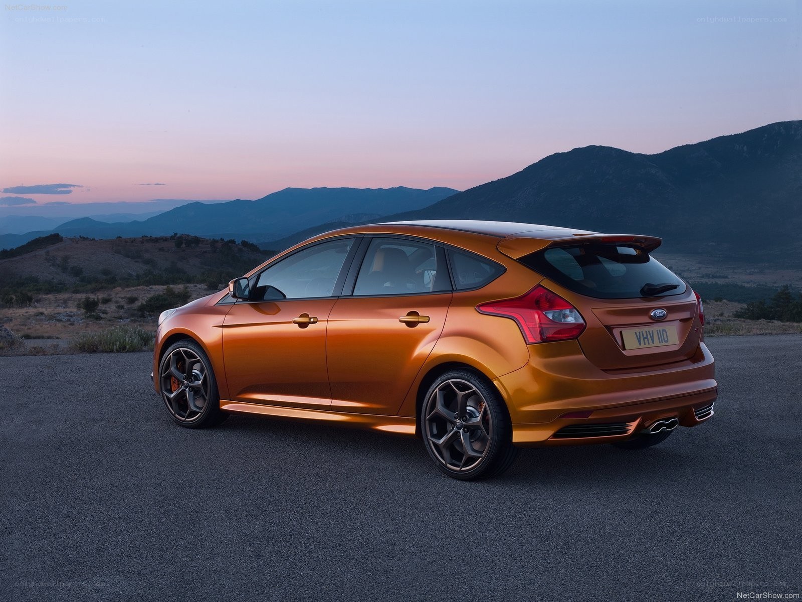 Orange Ford Focus ST parked at dusk
