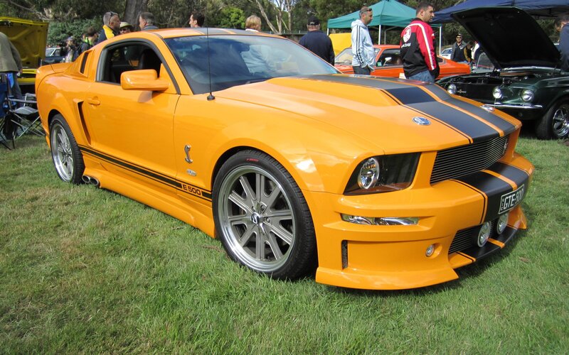 Orange Ford Mustang at car show