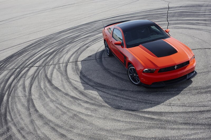 Orange Ford Mustang drifts