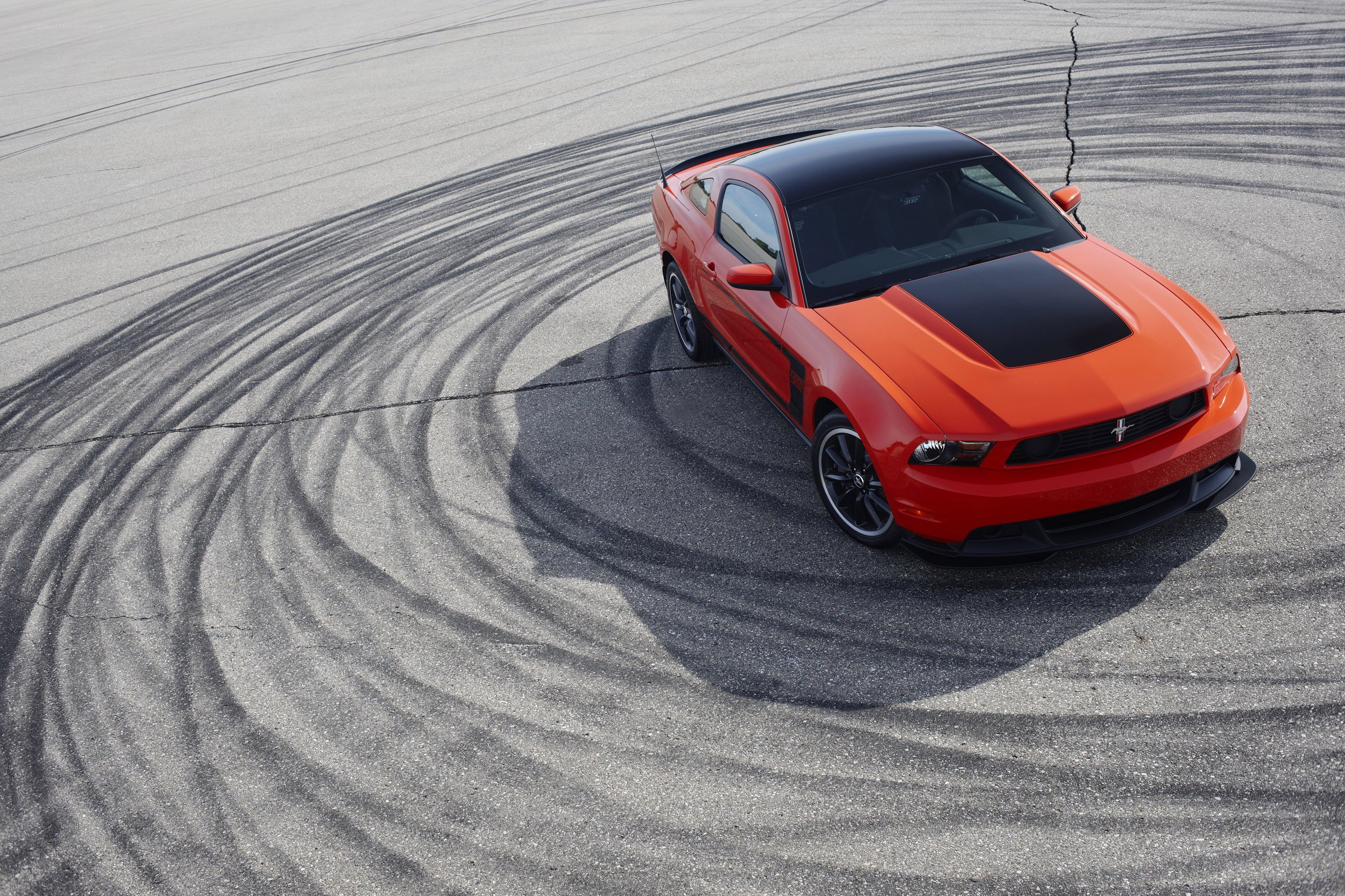 Orange Ford Mustang drifts