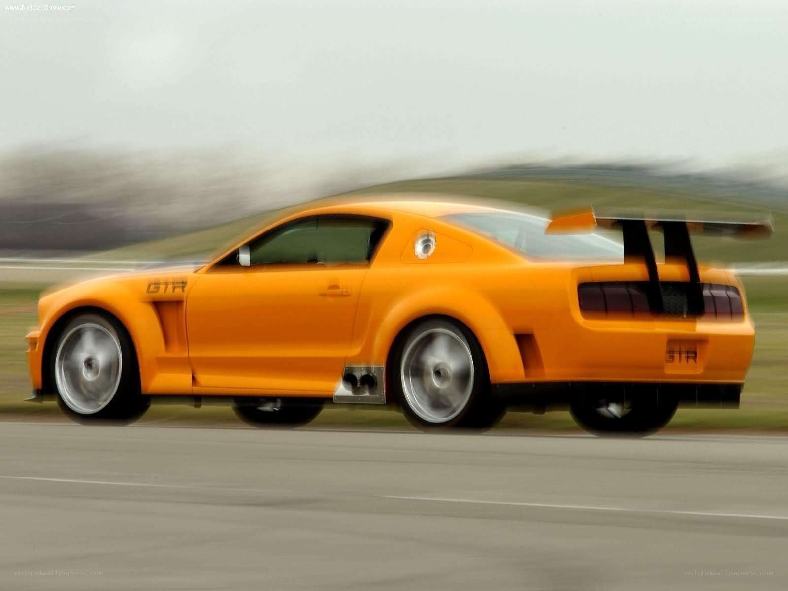 orange Ford Mustang GTR in motion