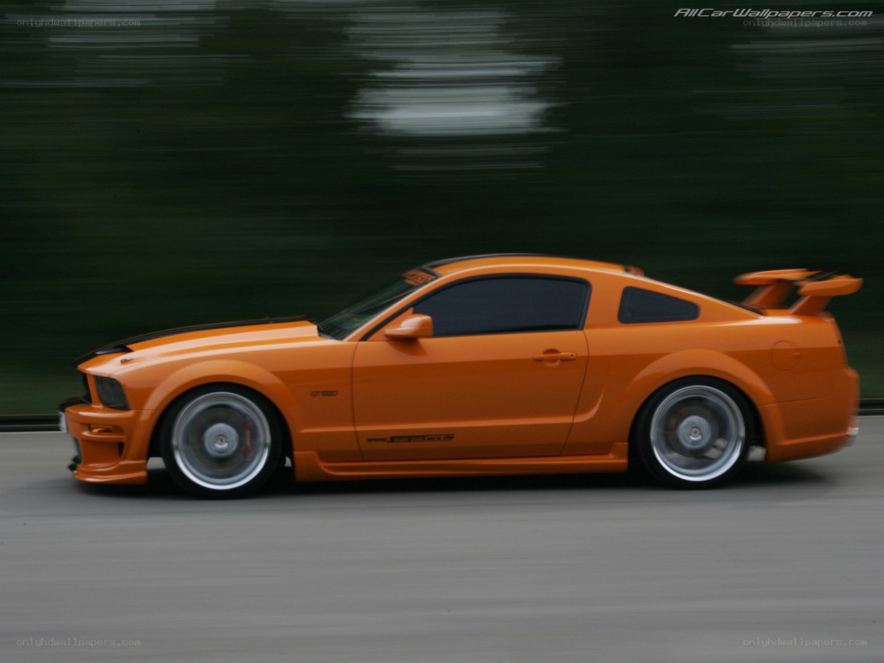 orange Ford Mustang in motion