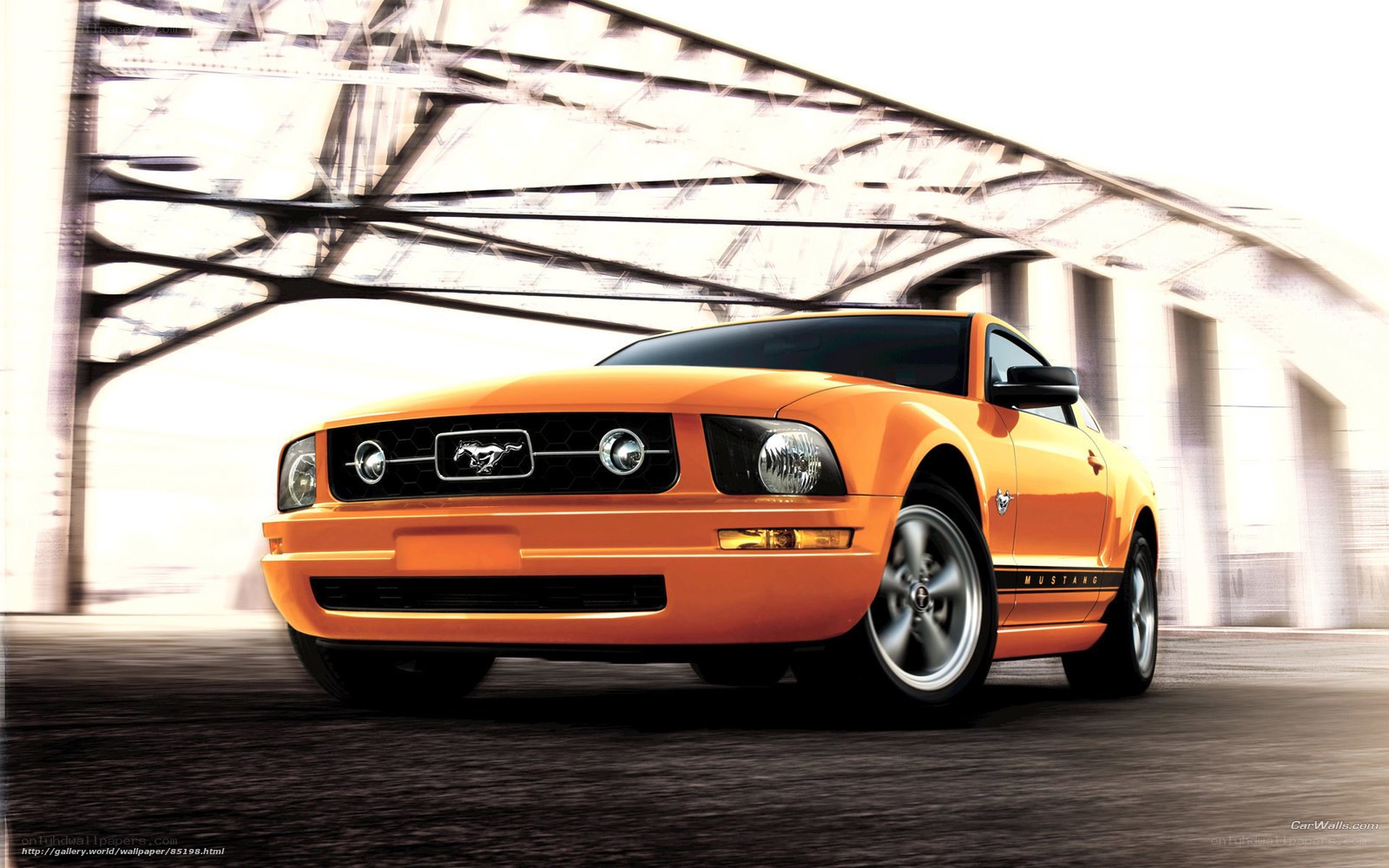 Orange Ford Mustang on a bridge