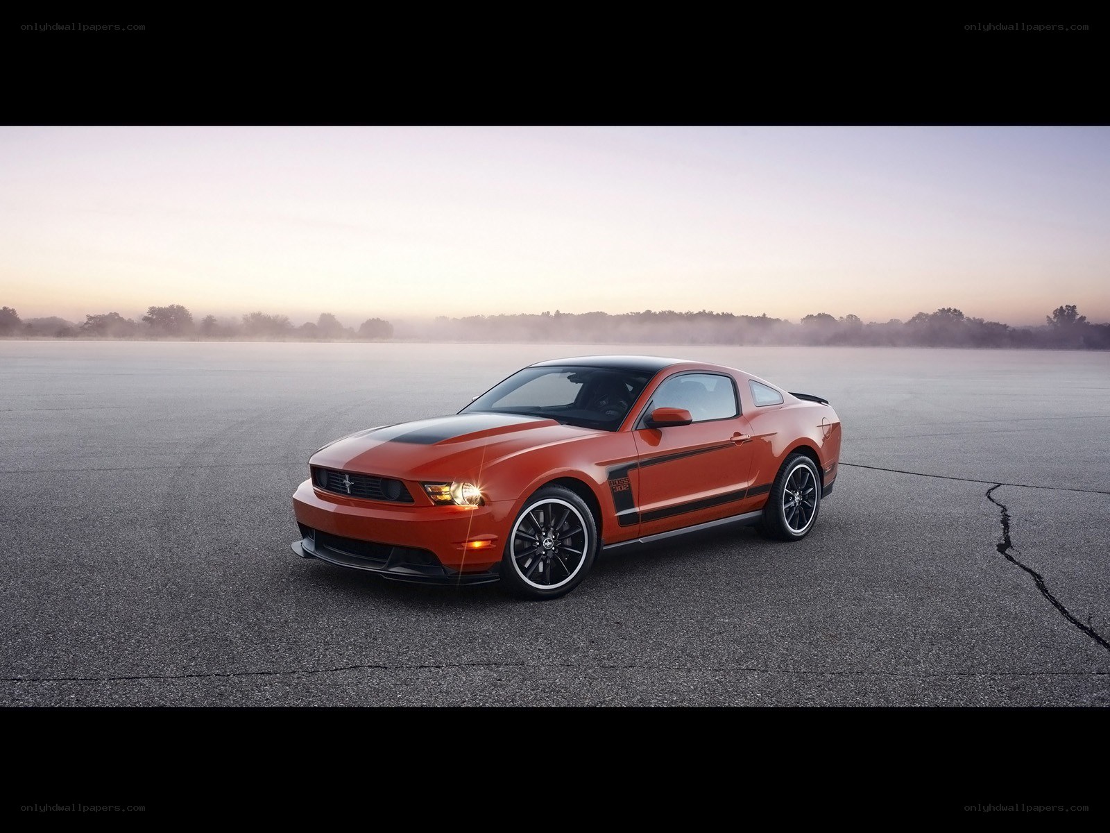 Orange Ford Mustang on a track